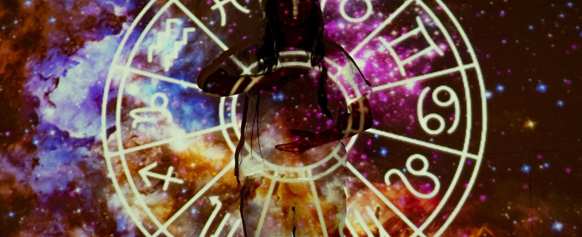 meditating woman standing in front of a projection